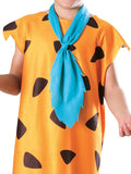 Child wearing a dress with brown spotted pattern and blue scarf on a white background