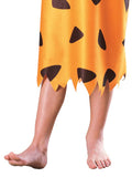 Orange loincloth with black triangles worn by a person on a white background